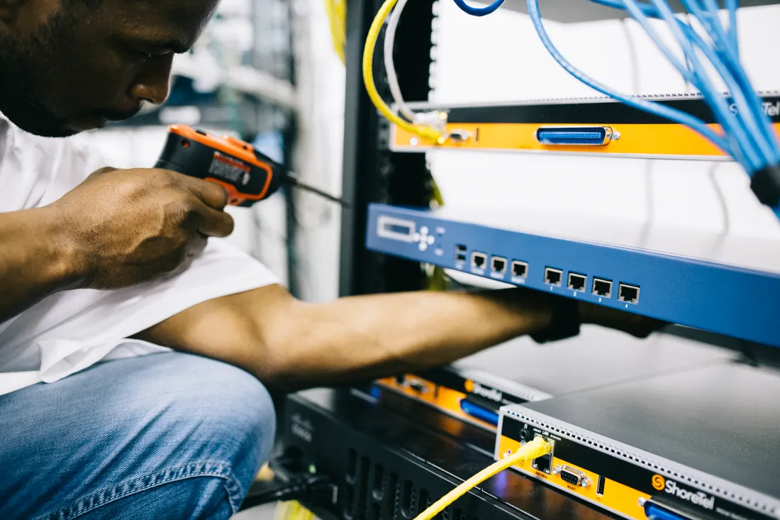 A technician working on network hardware