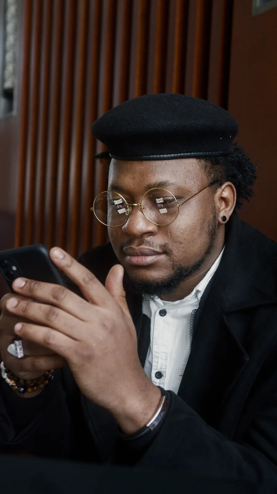 A man reading something on his phone in a cafe